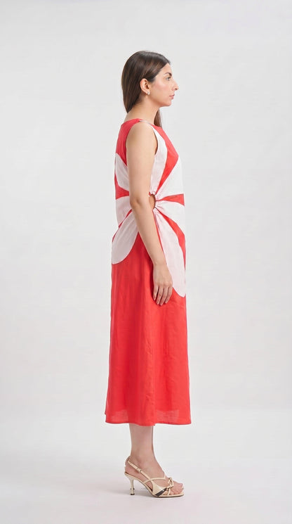 Woman wearing a red and white sleeveless dress on a white background