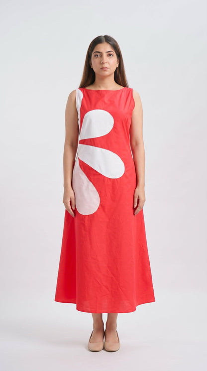 Woman wearing a red dress with a large white abstract design on a white background