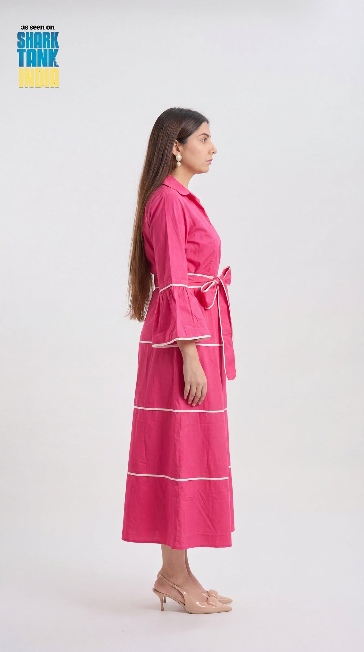 Woman wearing a pink robe with white stripes on a white background