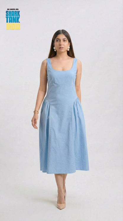 Woman wearing a light blue dress on a white background