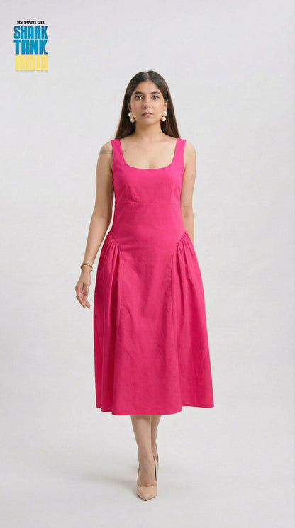 Woman wearing a pink dress on a white background with 'Shark Tank' logo.