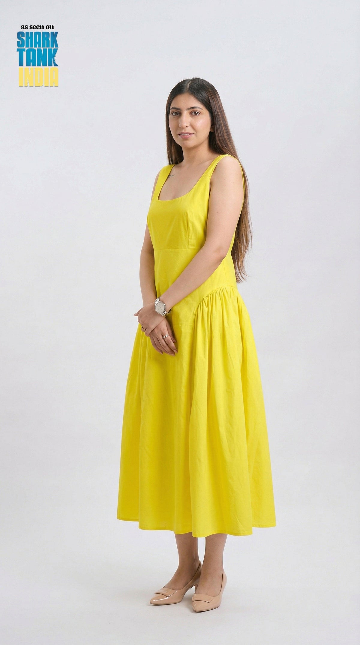 Woman wearing a yellow dress on a white background