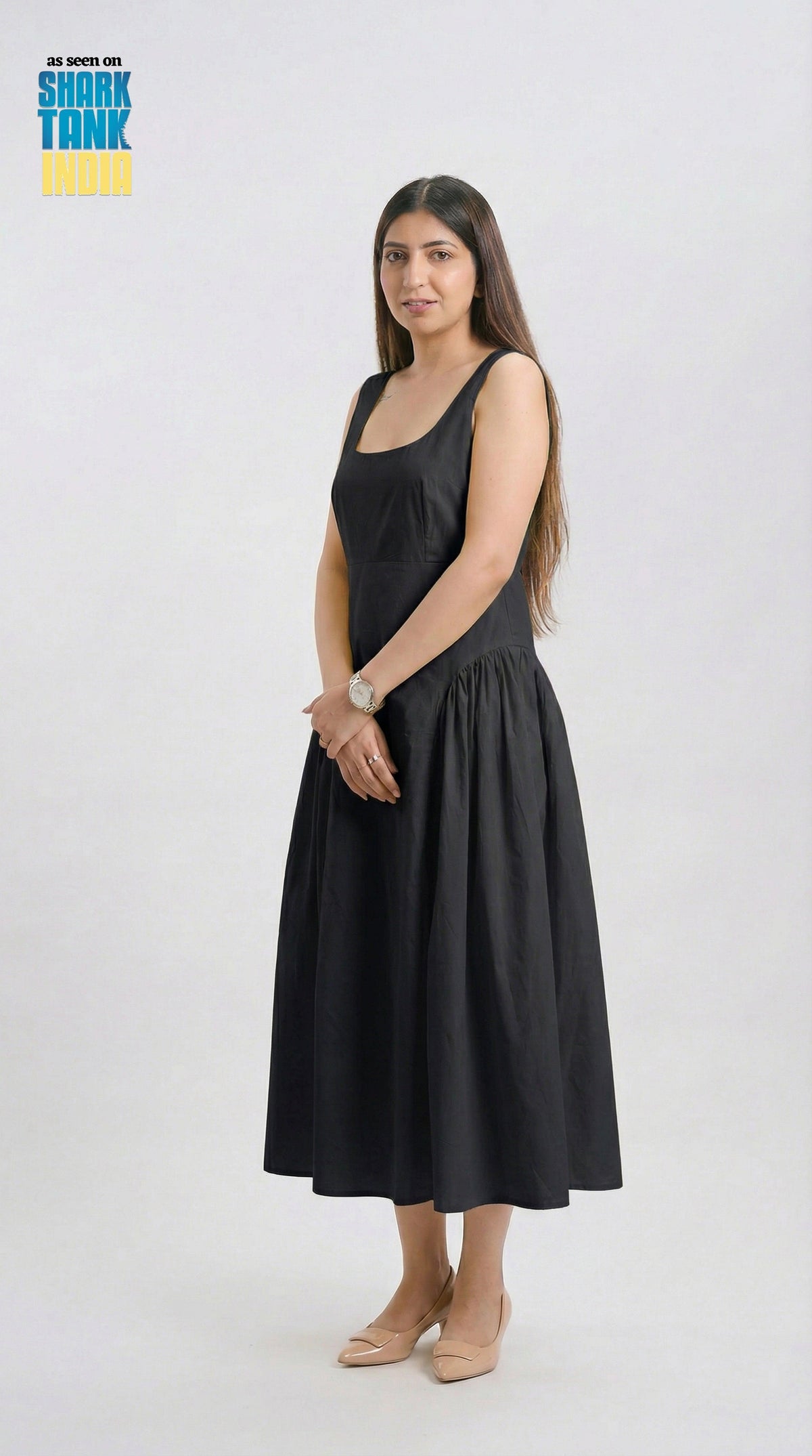 Woman wearing a black dress on a white background with 'Shark Tank' branding.