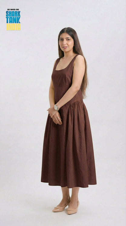 Woman wearing a brown dress on a white background with 'Shark Tank' logo.