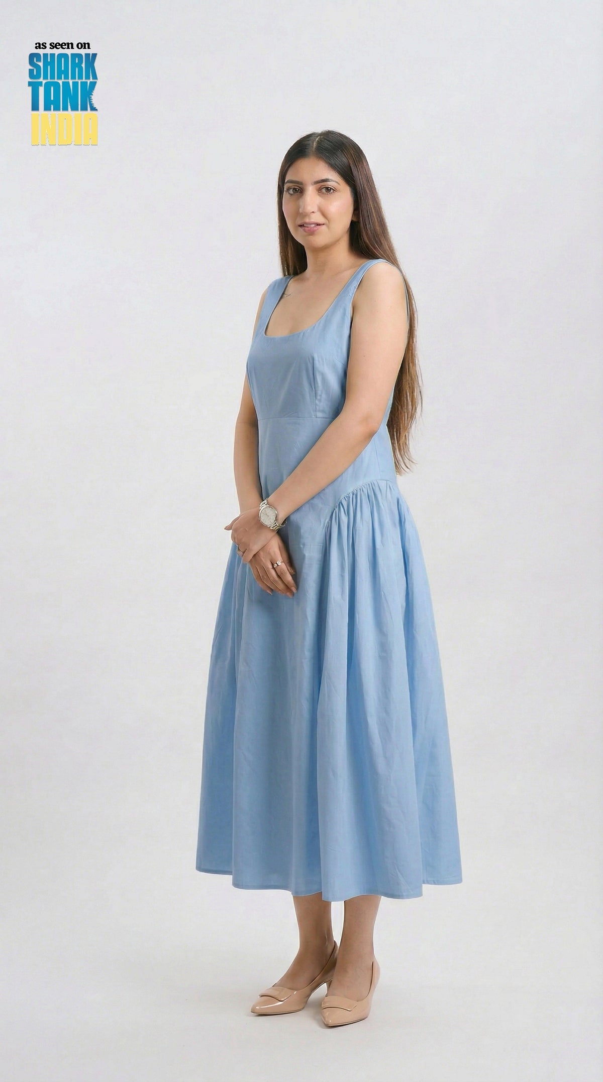 Woman wearing a light blue dress on a white background