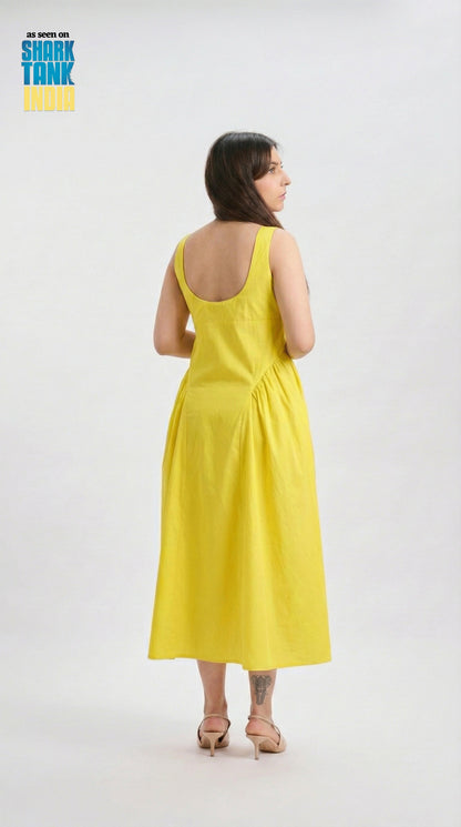 Woman wearing a yellow dress on a white background with 'Shark Tank' branding.