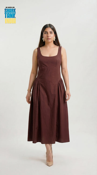 Woman wearing a brown dress on a white background with Shark Tank logo.