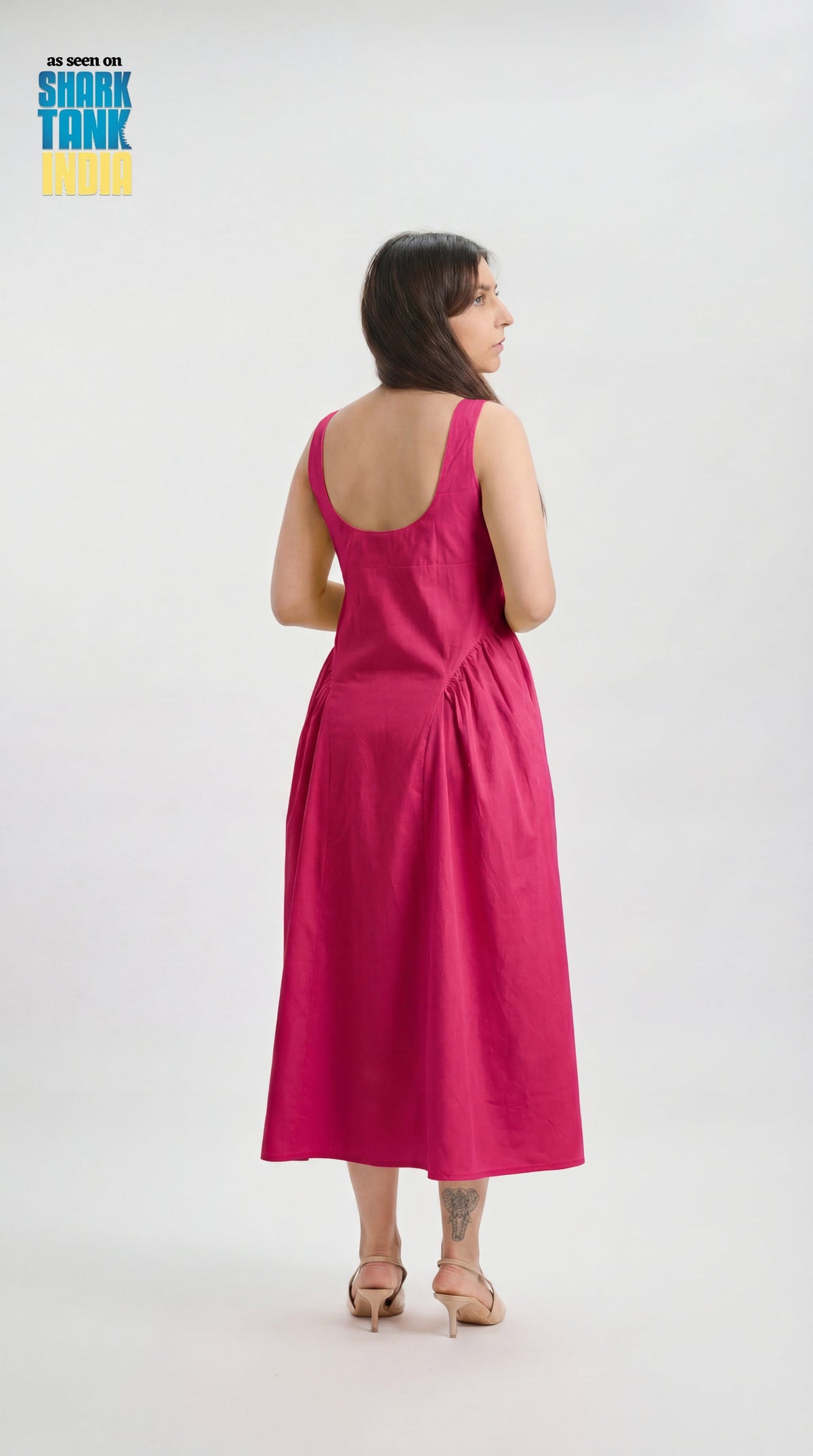 Woman wearing a pink dress on a white background with 'Shark Tank' branding.
