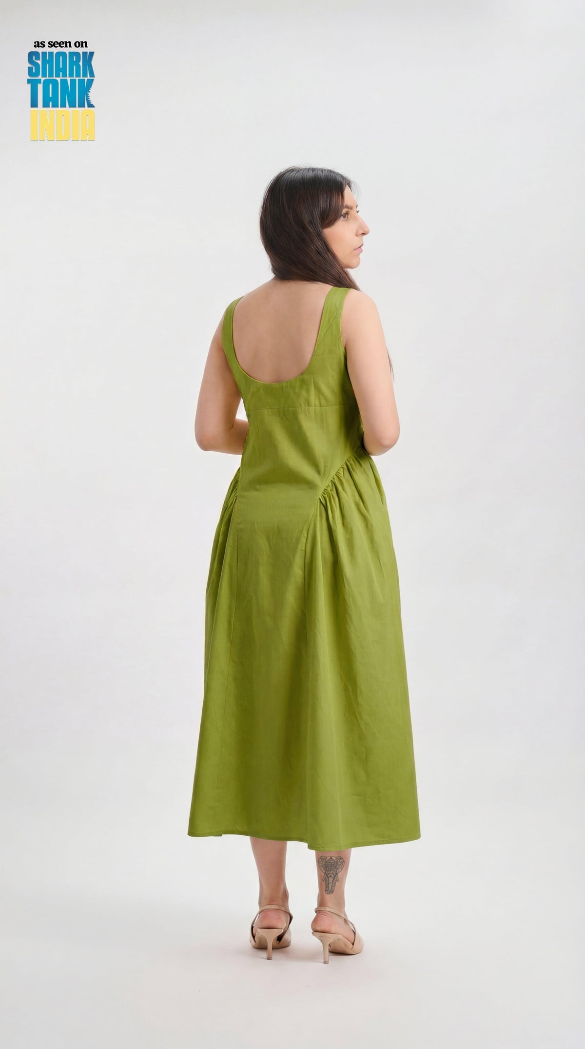 Woman wearing a green dress on a white background with 'Shark Tank' branding.