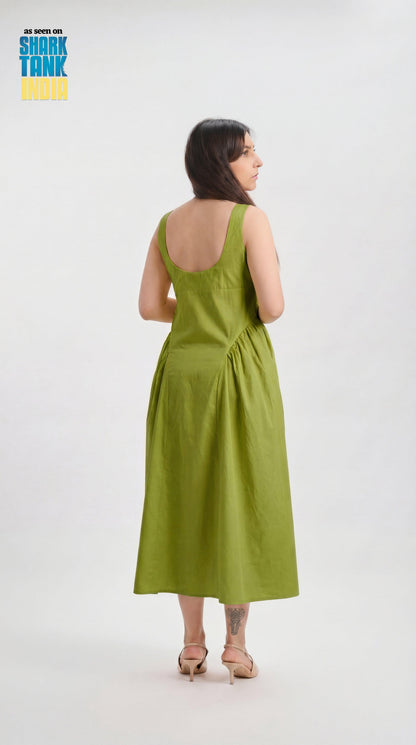 Woman wearing a green dress on a white background with 'Shark Tank' branding.