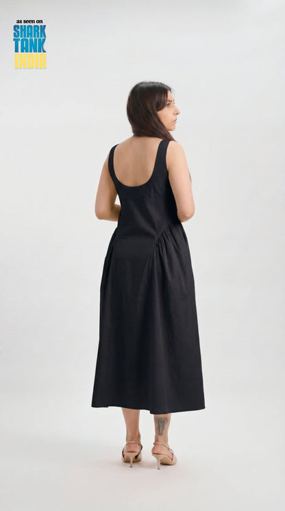 Woman wearing a black sleeveless dress on a white background with 'Shark Tank' branding.