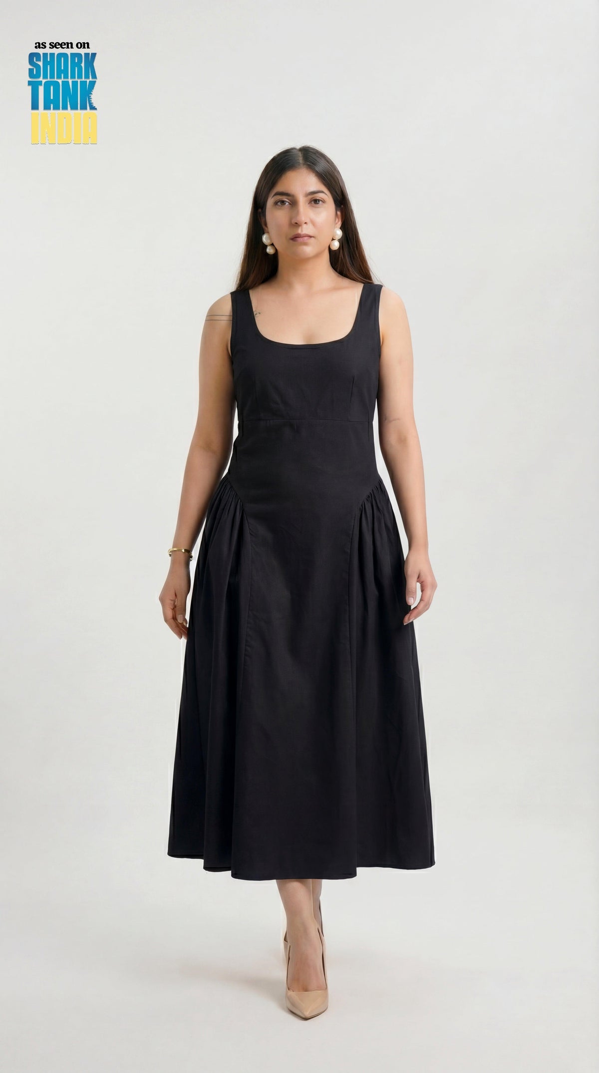 Woman wearing a black sleeveless dress on a white background