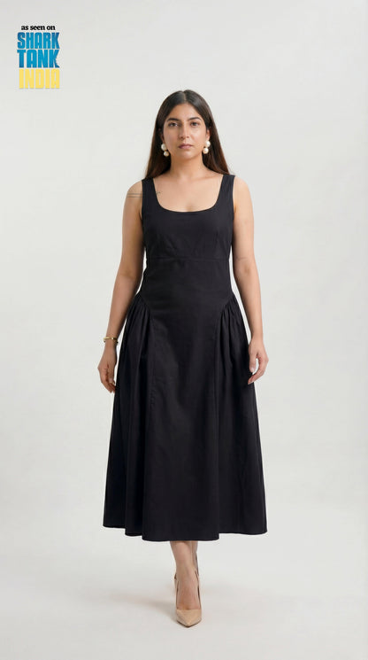 Woman wearing a black sleeveless dress on a white background