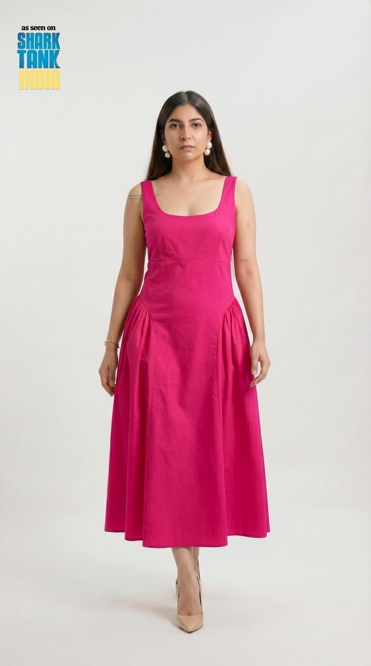 Woman wearing a pink dress on a white background with 'Shark Tank' branding.