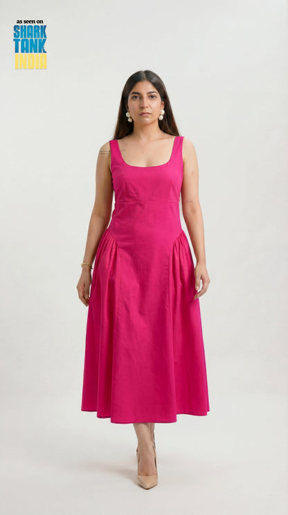 Woman wearing a pink dress on a white background with 'Shark Tank' branding.