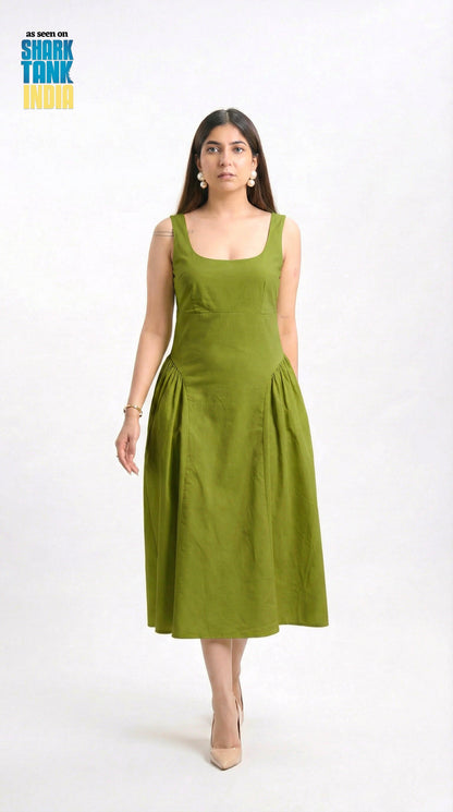 Woman wearing a green dress on a white background with 'Shark Tank India' logo.