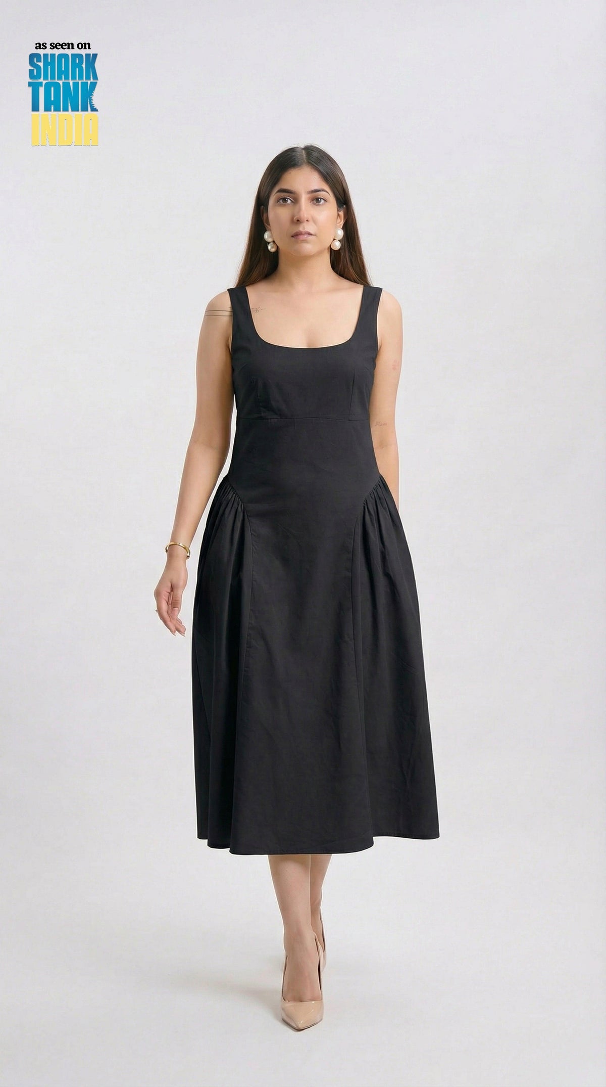 Woman wearing a black sleeveless dress on a white background