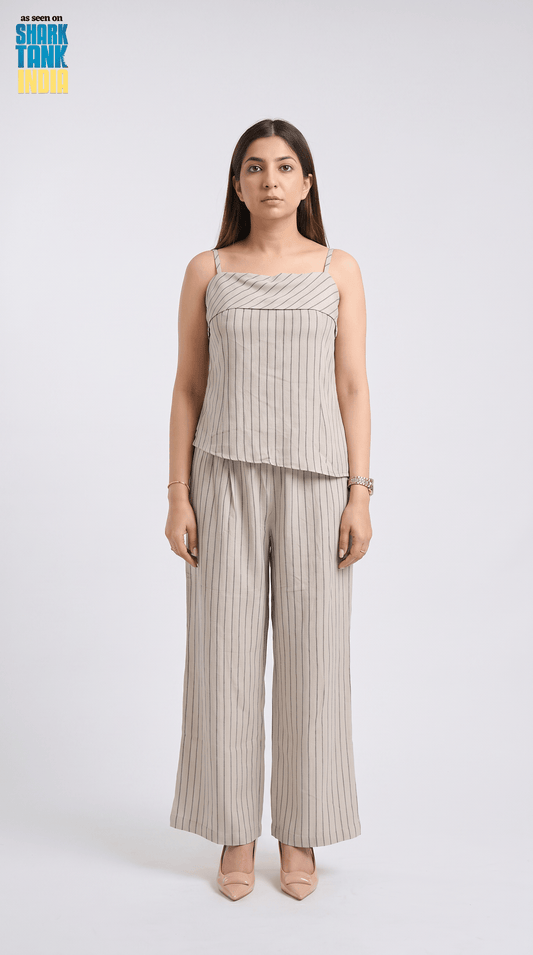 Woman wearing a striped top and wide-leg pants on a white background
