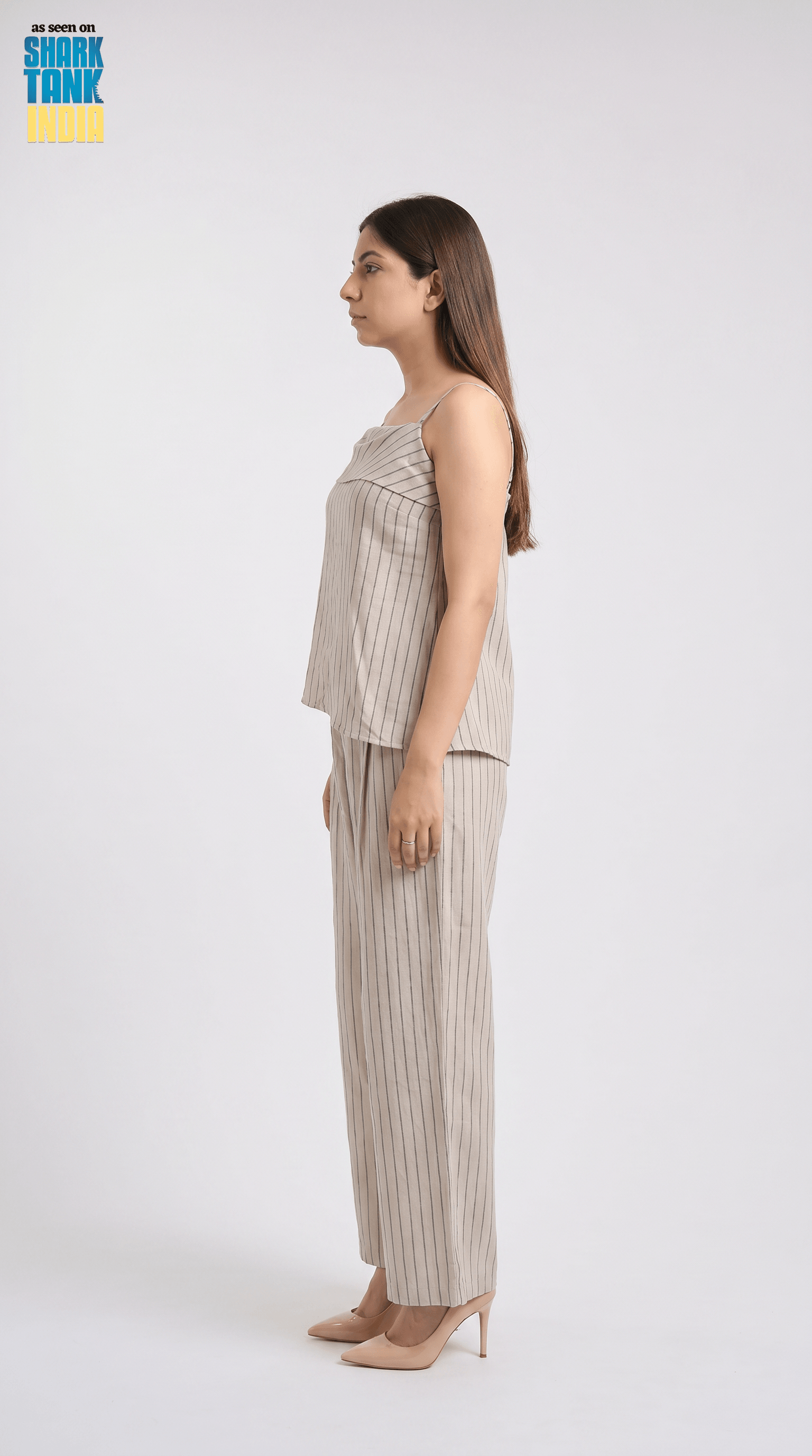 Woman wearing a beige striped outfit on a white background