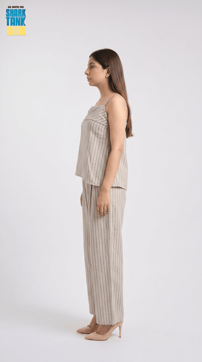 Woman wearing a beige striped outfit on a white background