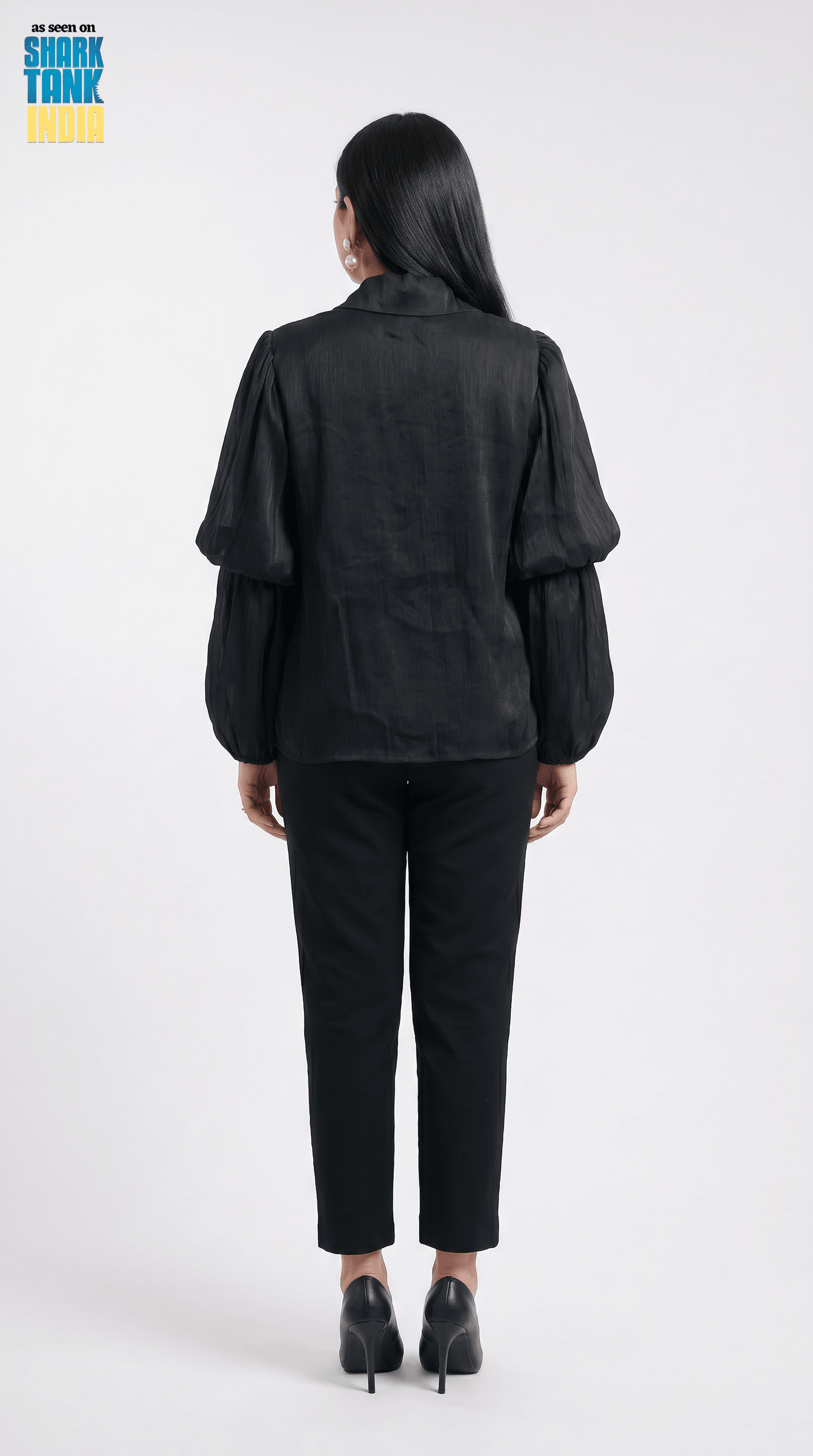 Person wearing a black outfit on a white background with 'Shark Tank' branding.