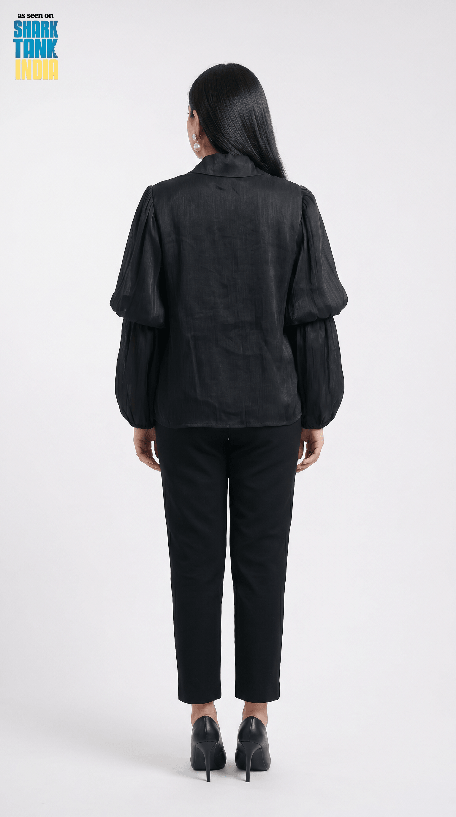 Person wearing a black outfit on a white background with 'Shark Tank' branding.