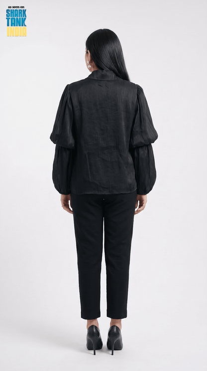 Person wearing a black outfit on a white background with 'Shark Tank' branding.