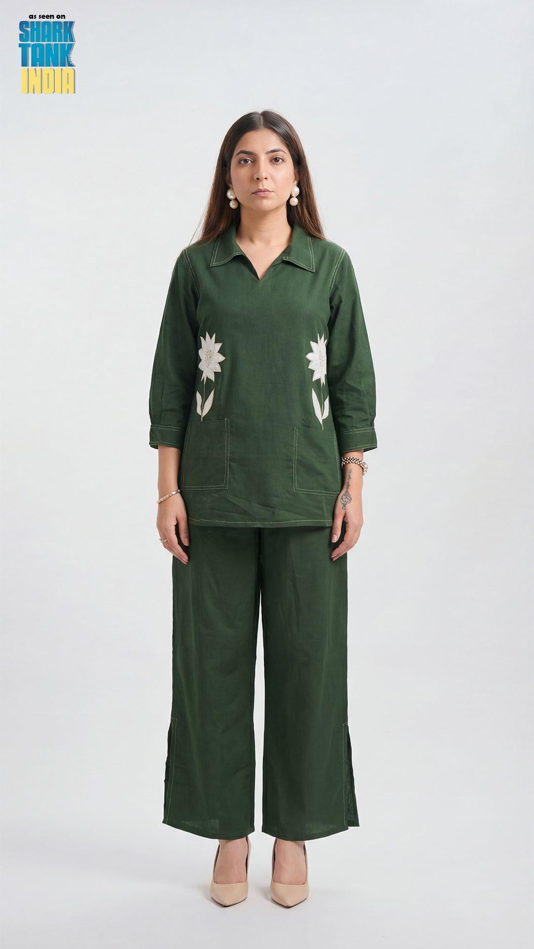 Woman wearing a green outfit with floral patterns on a white background