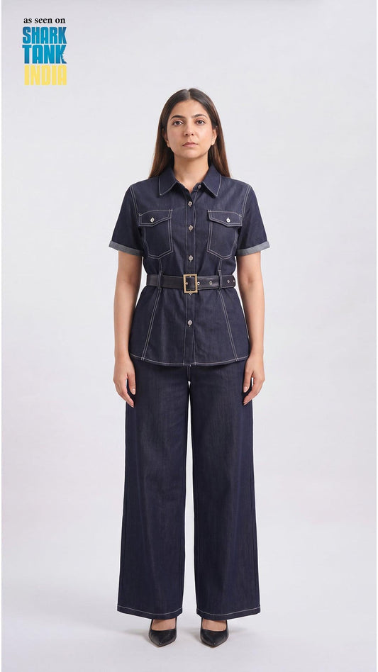 Woman wearing a denim outfit with a belt on a white background, featuring 'Shark Tank' branding.