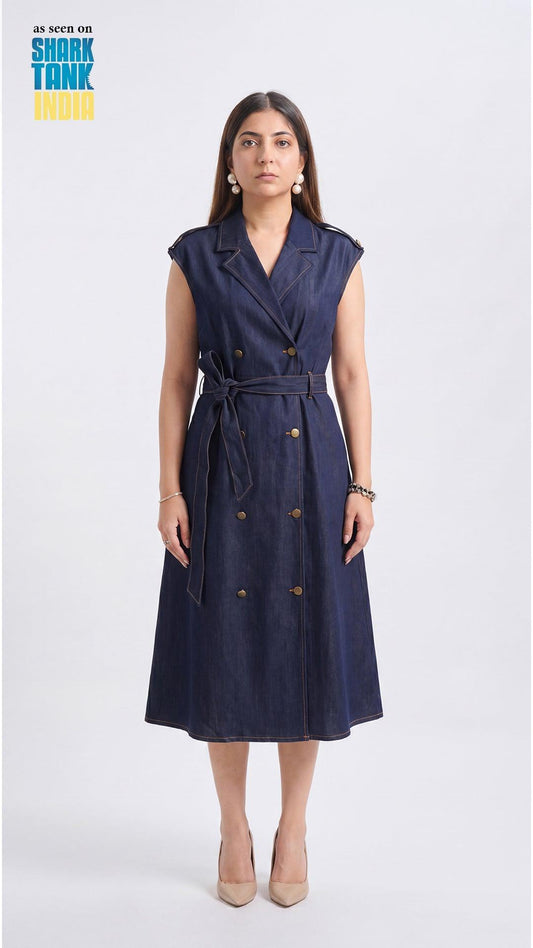Woman wearing a navy blue dress with buttons on a white background