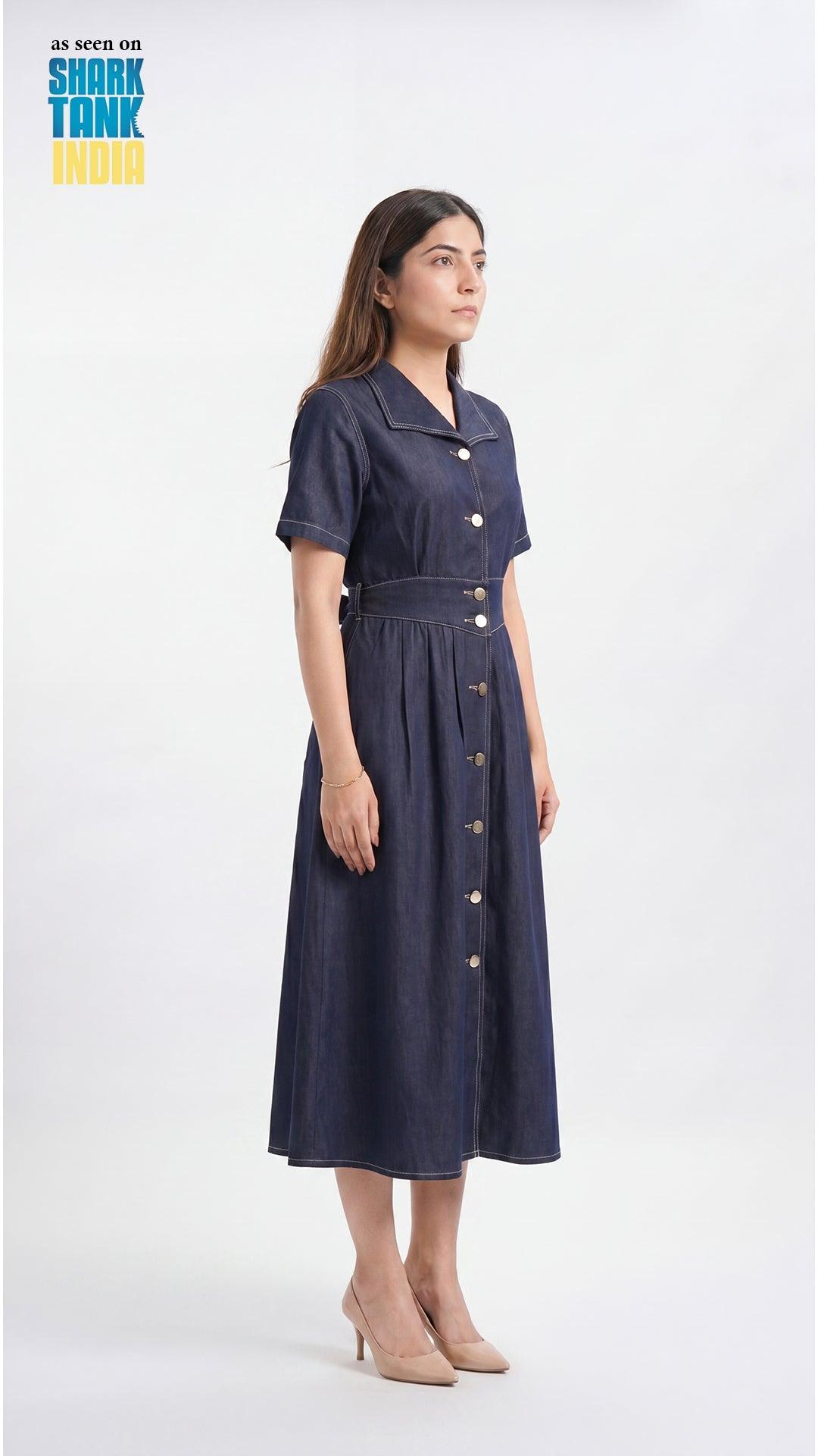Woman wearing a navy dress with buttons on a white background
