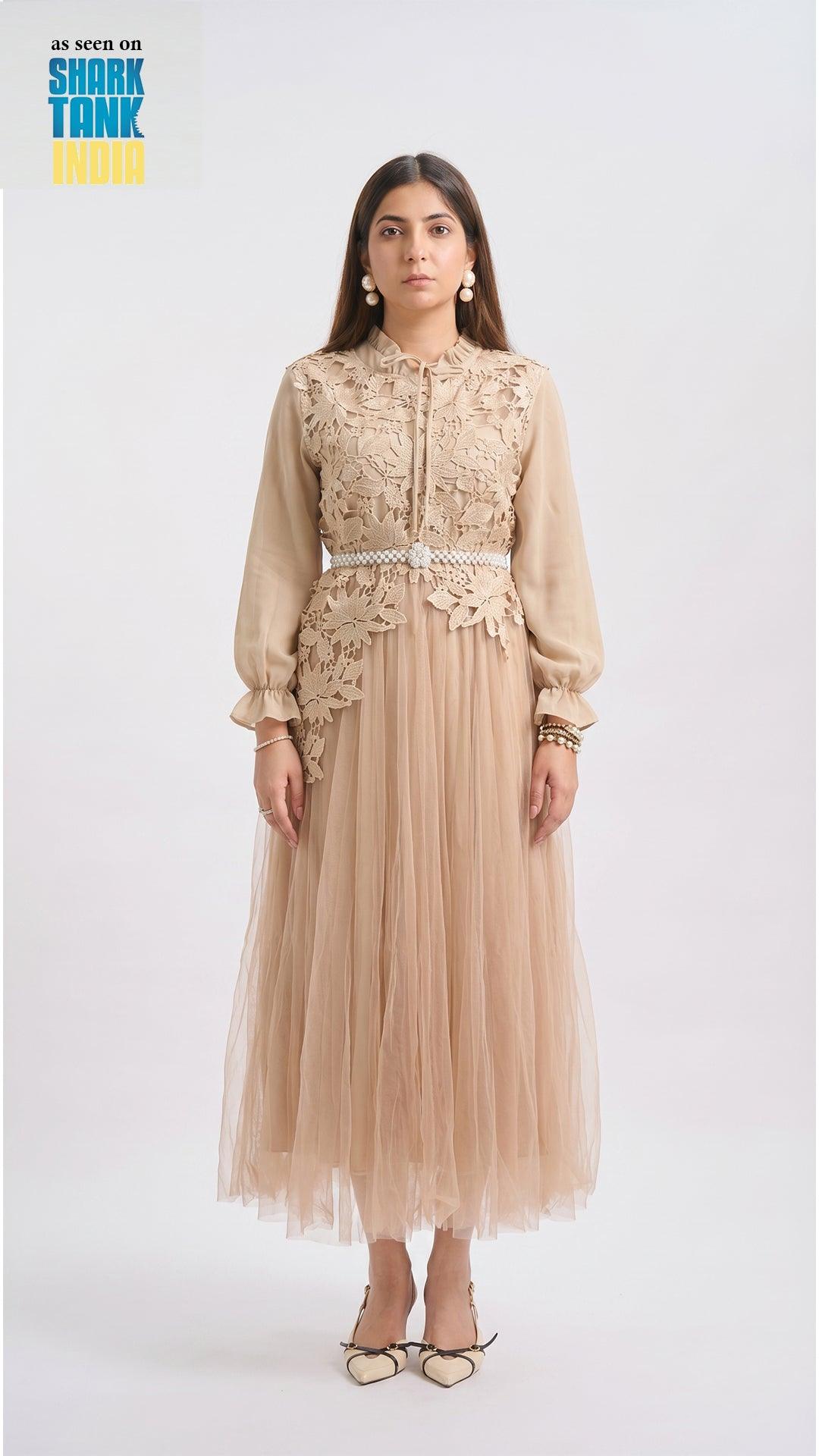 Woman wearing a beige lace dress with a white background