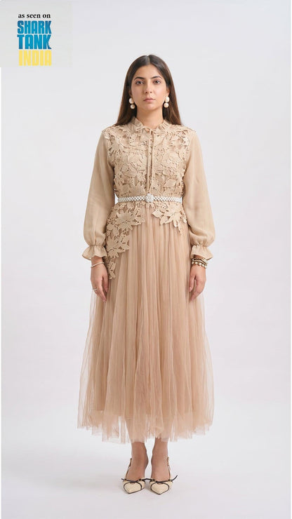 Woman wearing a beige lace dress with a white background
