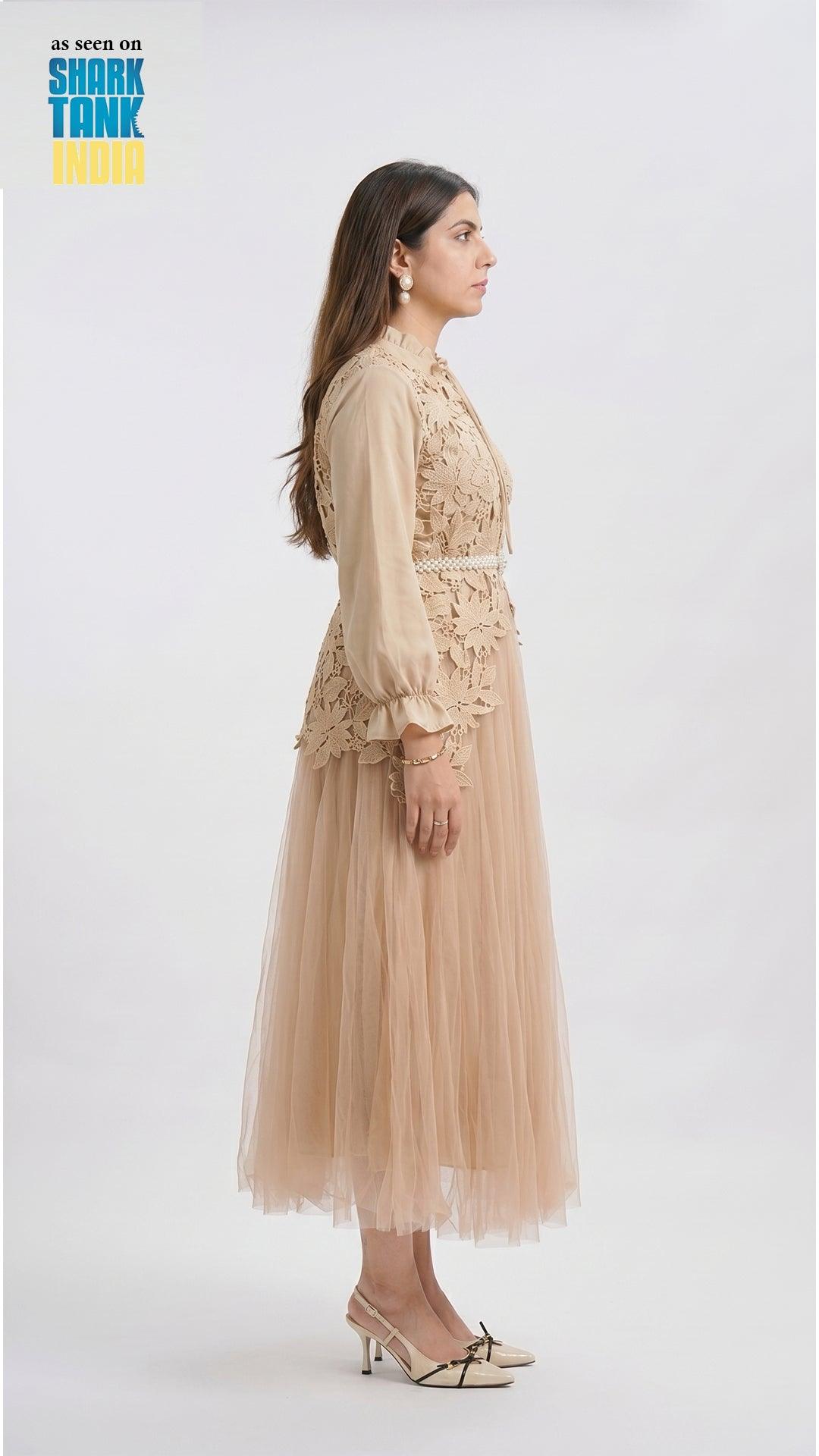 Woman wearing a beige dress with lace details on a white background