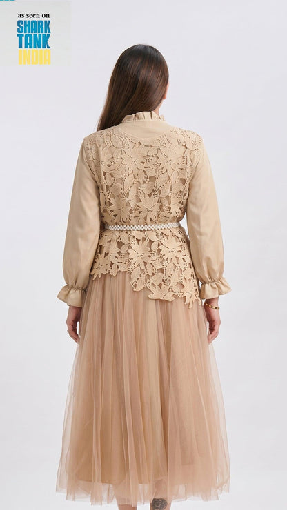 Woman wearing a beige lace top and tulle skirt on a white background