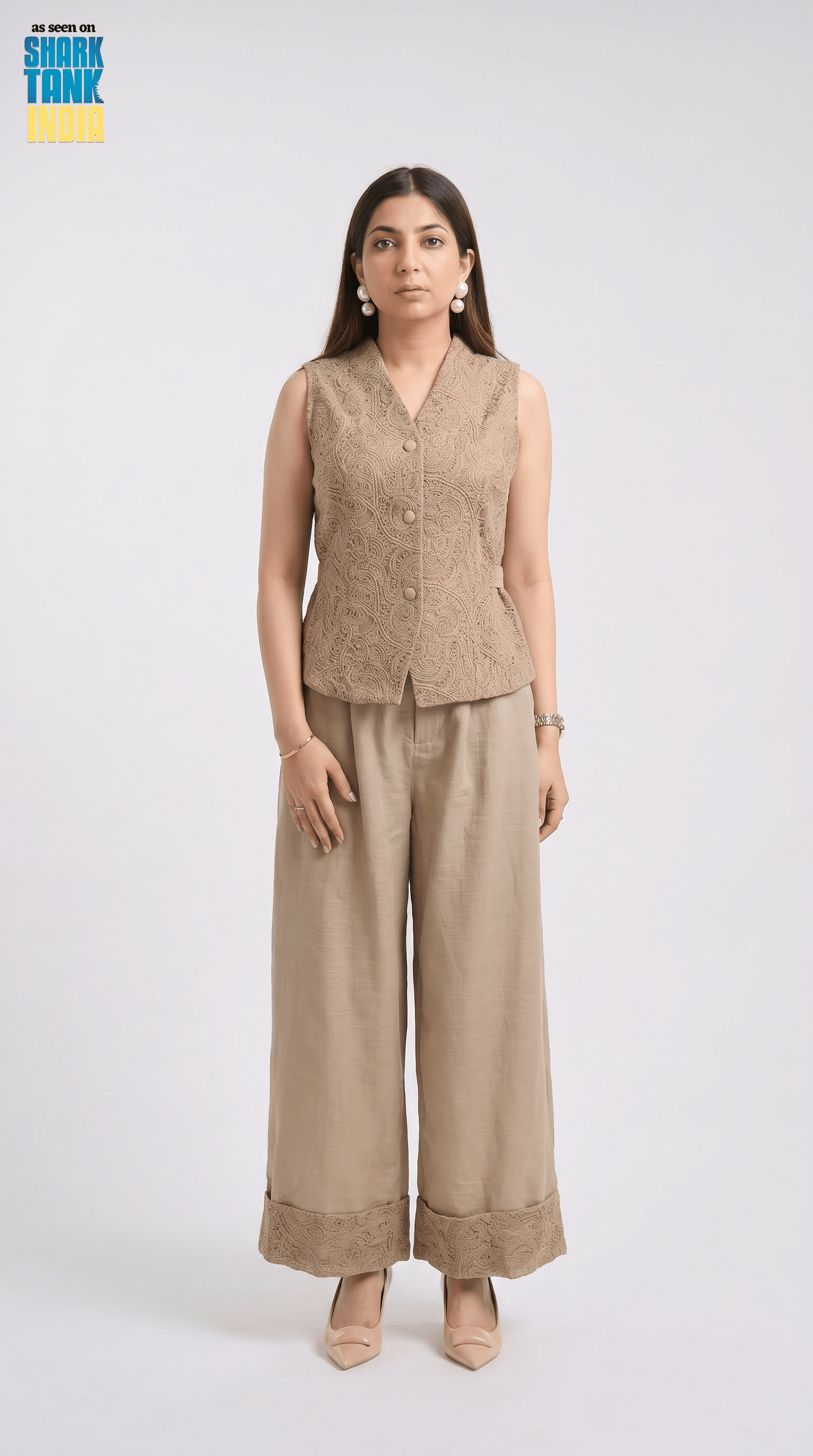 Woman wearing a beige sleeveless top and wide-leg pants on a white background