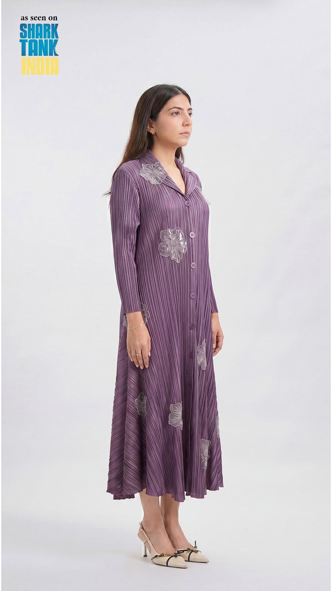Woman wearing a purple dress with patterns on a white background