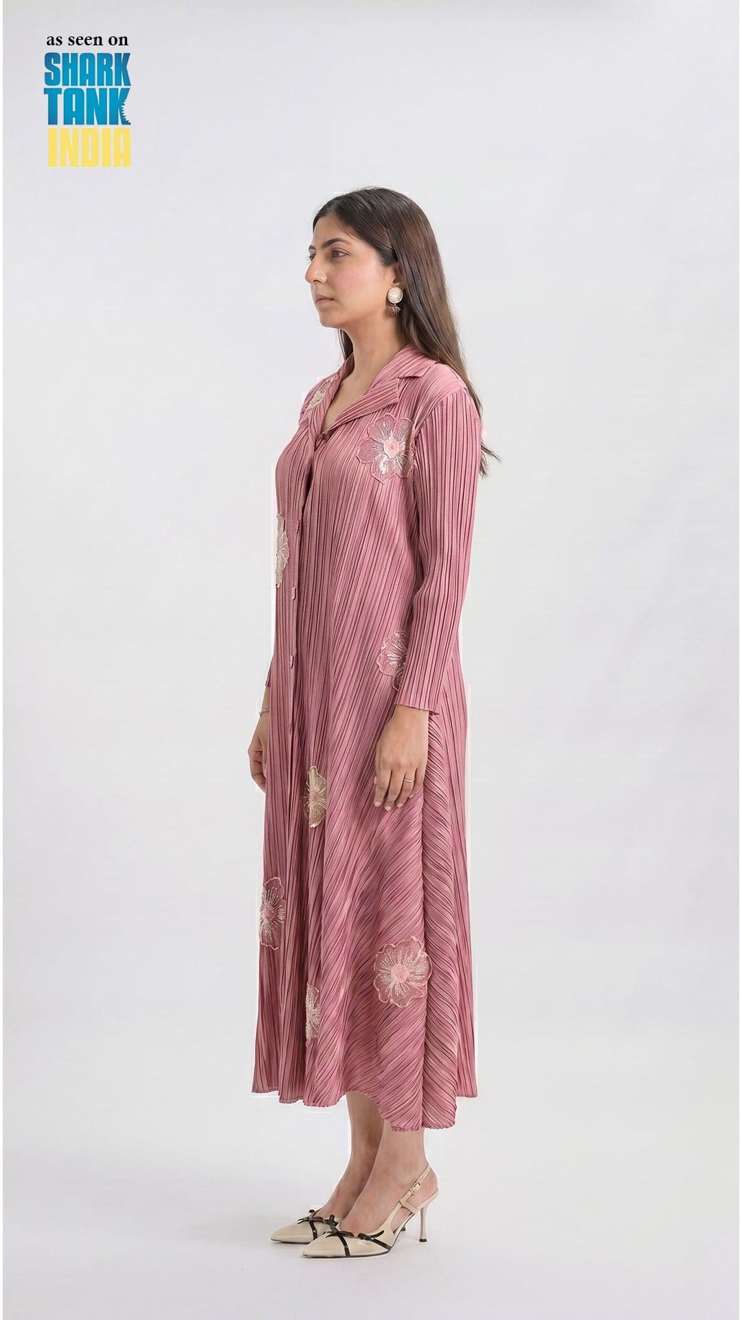 Woman wearing a pink striped dress with floral patterns on a white background