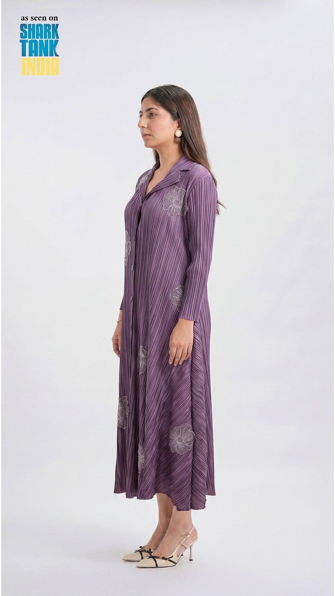 Woman wearing a long purple dress with a pattern on a white background
