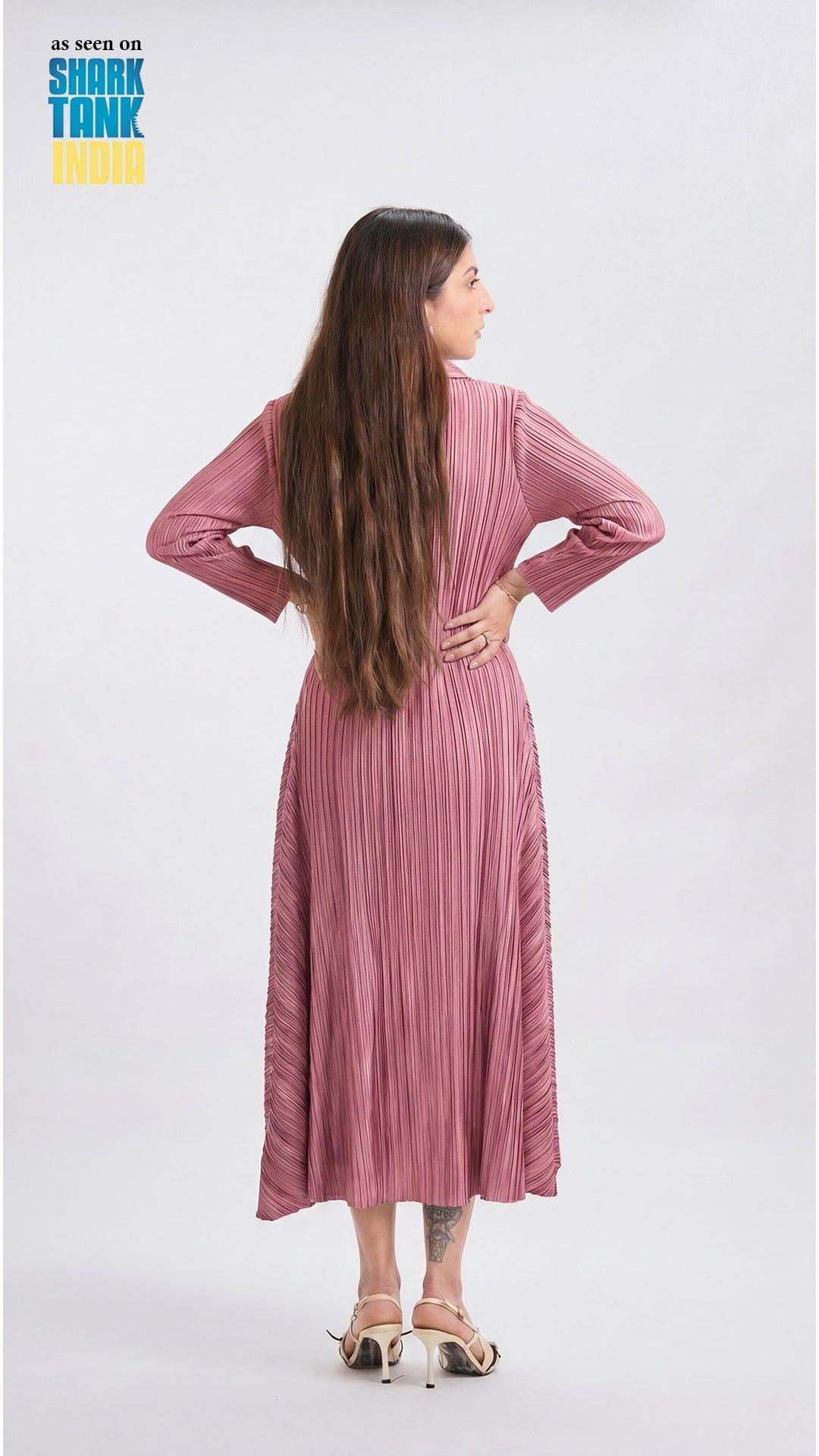 Woman wearing a pink pleated dress on a white background with 'Shark Tank' branding.