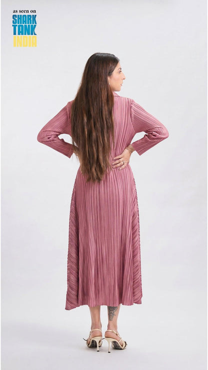 Woman wearing a pink pleated dress on a white background with 'Shark Tank' branding.