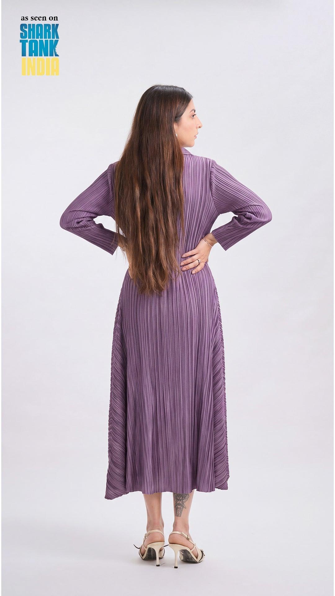 Woman wearing a purple pleated dress on a white background with 'Shark Tank' branding.