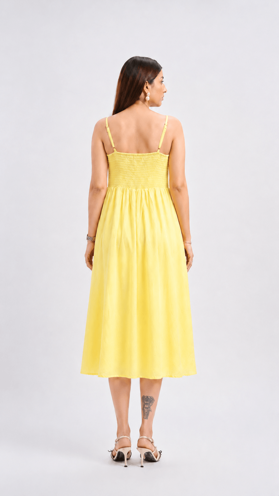 Woman wearing a yellow dress on a white background