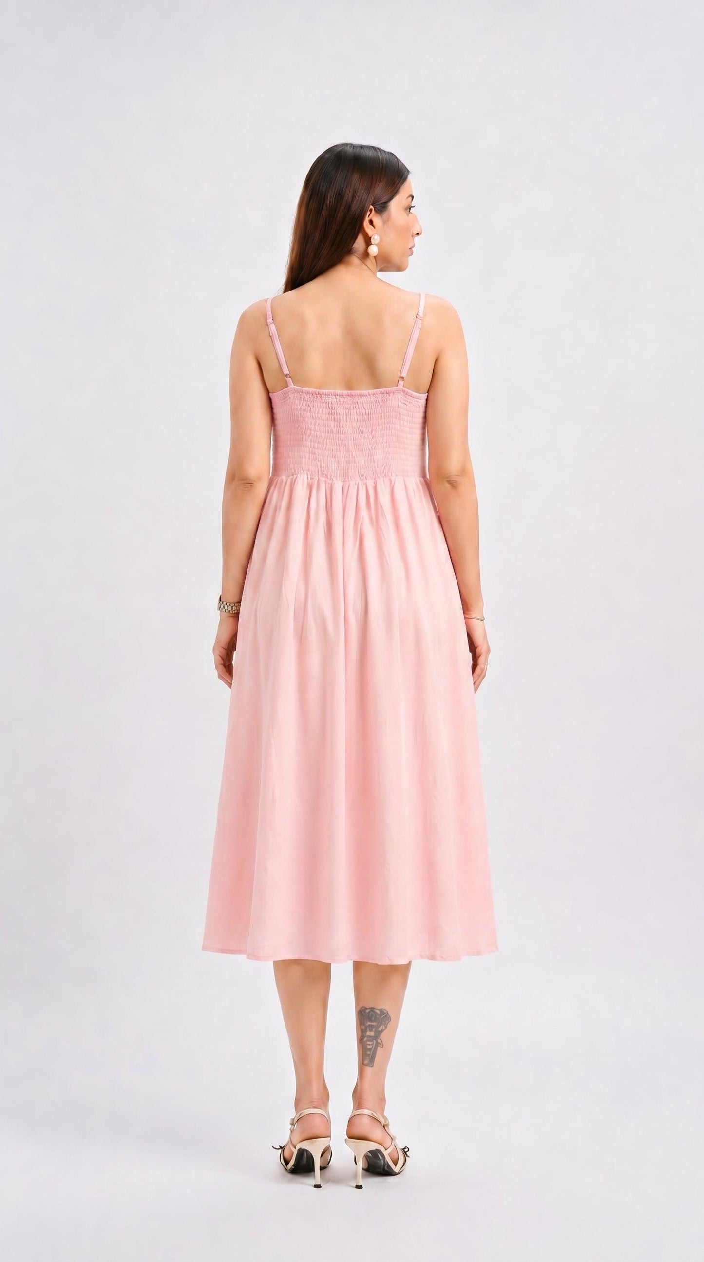 Woman wearing a pink dress on a white background