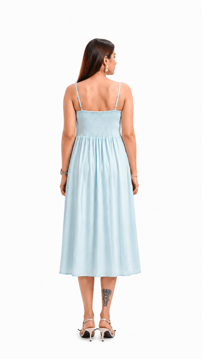 Woman wearing a light blue dress on a white background