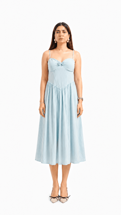 Woman wearing a light blue dress on a white background
