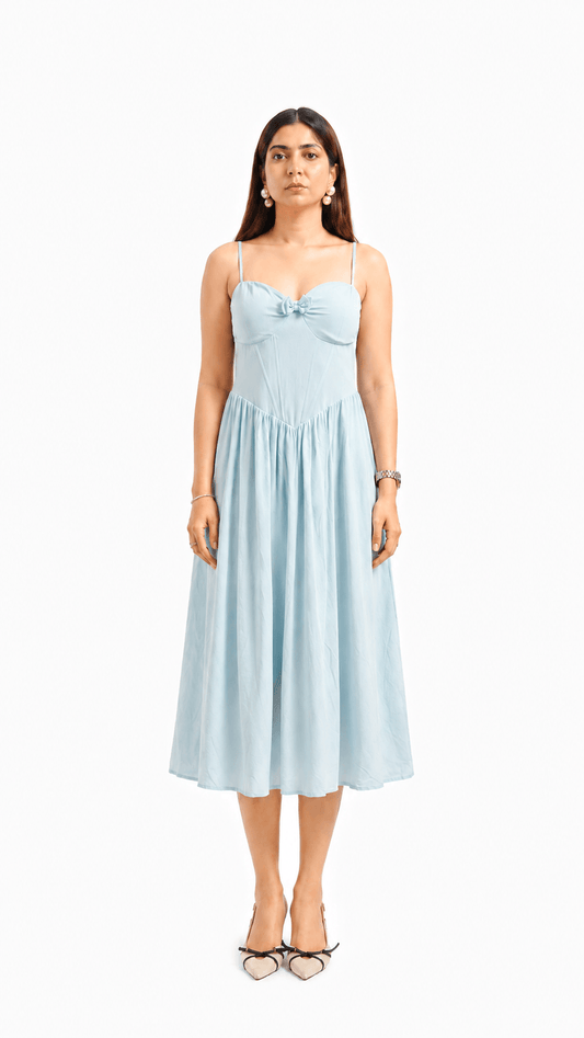 Woman wearing a light blue dress on a white background