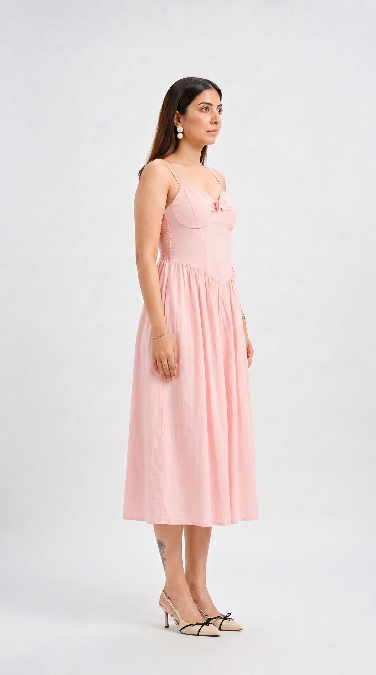 Woman wearing a pink dress on a white background