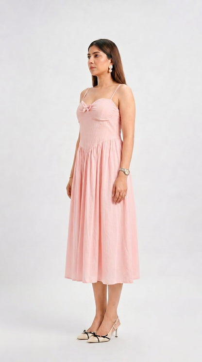 Woman wearing a pink dress on a white background