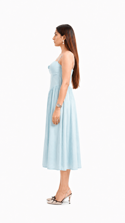Woman wearing a light blue strapless dress on a white background